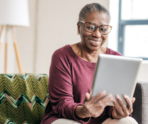 Older woman surfing the internet while in assisted living in Ann Arbor.