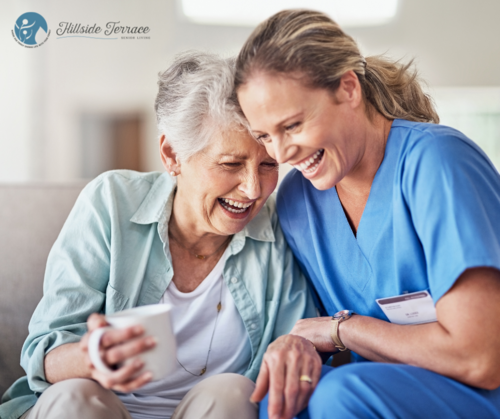 Caregiver hugging an older woman in assisted living.