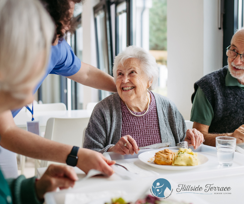 a lady smiling at dinner at Hillside Terrace assisted living in Ann Arbor